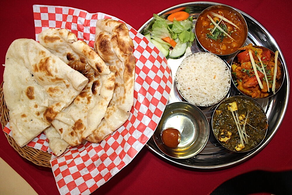 tasty thali with naan bread clear